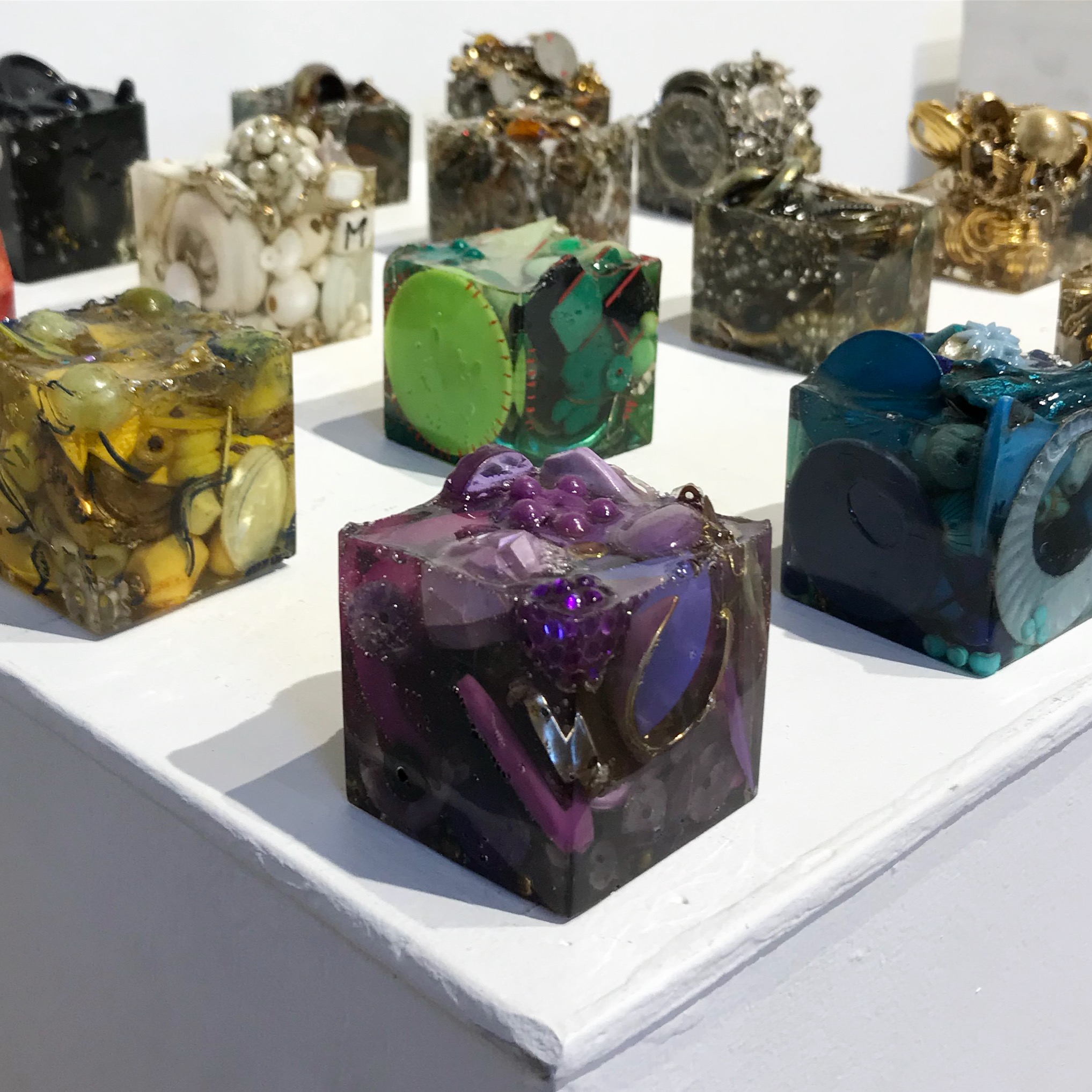  Sugar Cubes, 2019, costume jewelry, faux pearls, rhinestones, beads, keys, and found objects cast in resin, 2x2” 