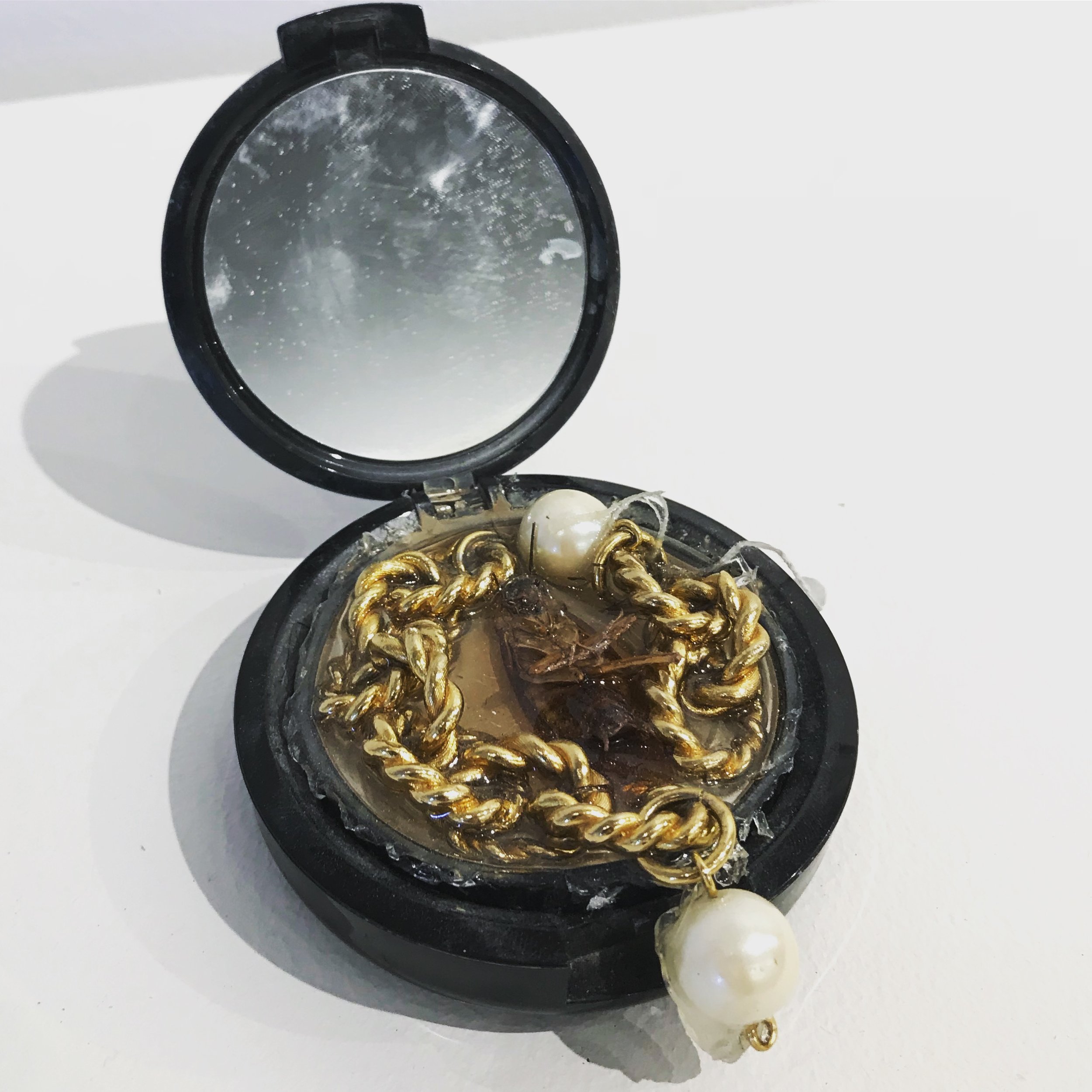   Makeup Compact No. 1,  2018, cockroach, costume jewelry, resin, and used makeup compact, 3x3x3” 