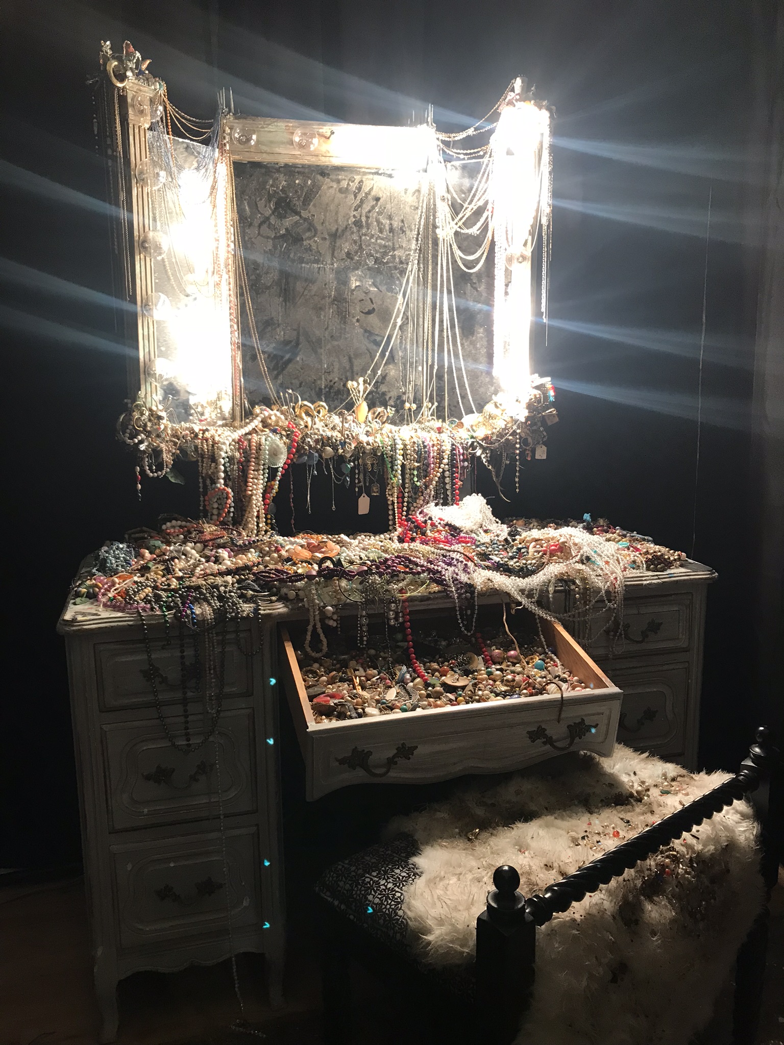   Vanity Installation,  2019, costume jewelry, found objects, chains, and faux pearls on wooden vanity mirror 