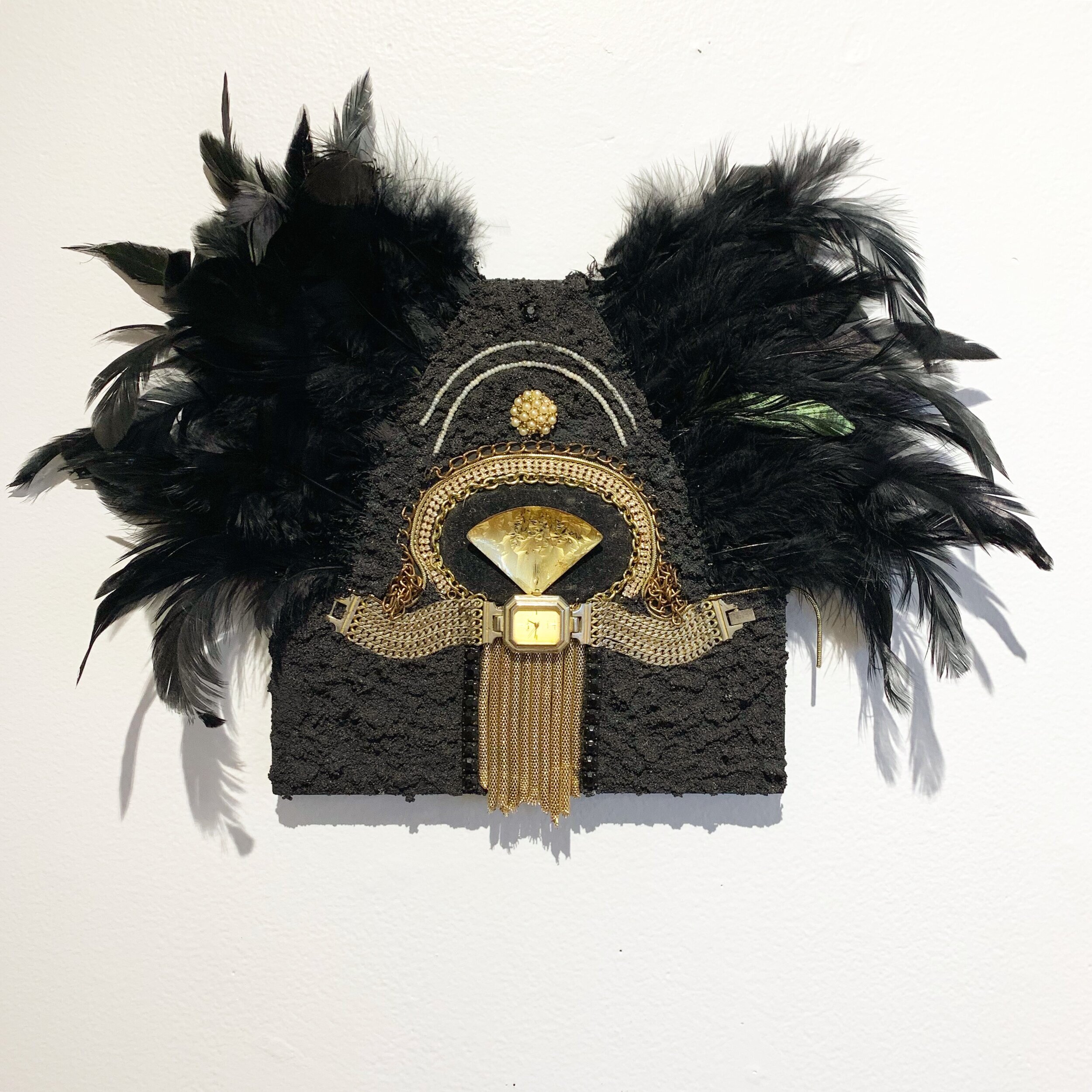   Far Feathered,  2020, costume jewelry, wrist watch, faux pearls, faux feathers, and pumice medium on panel, 8x8” 