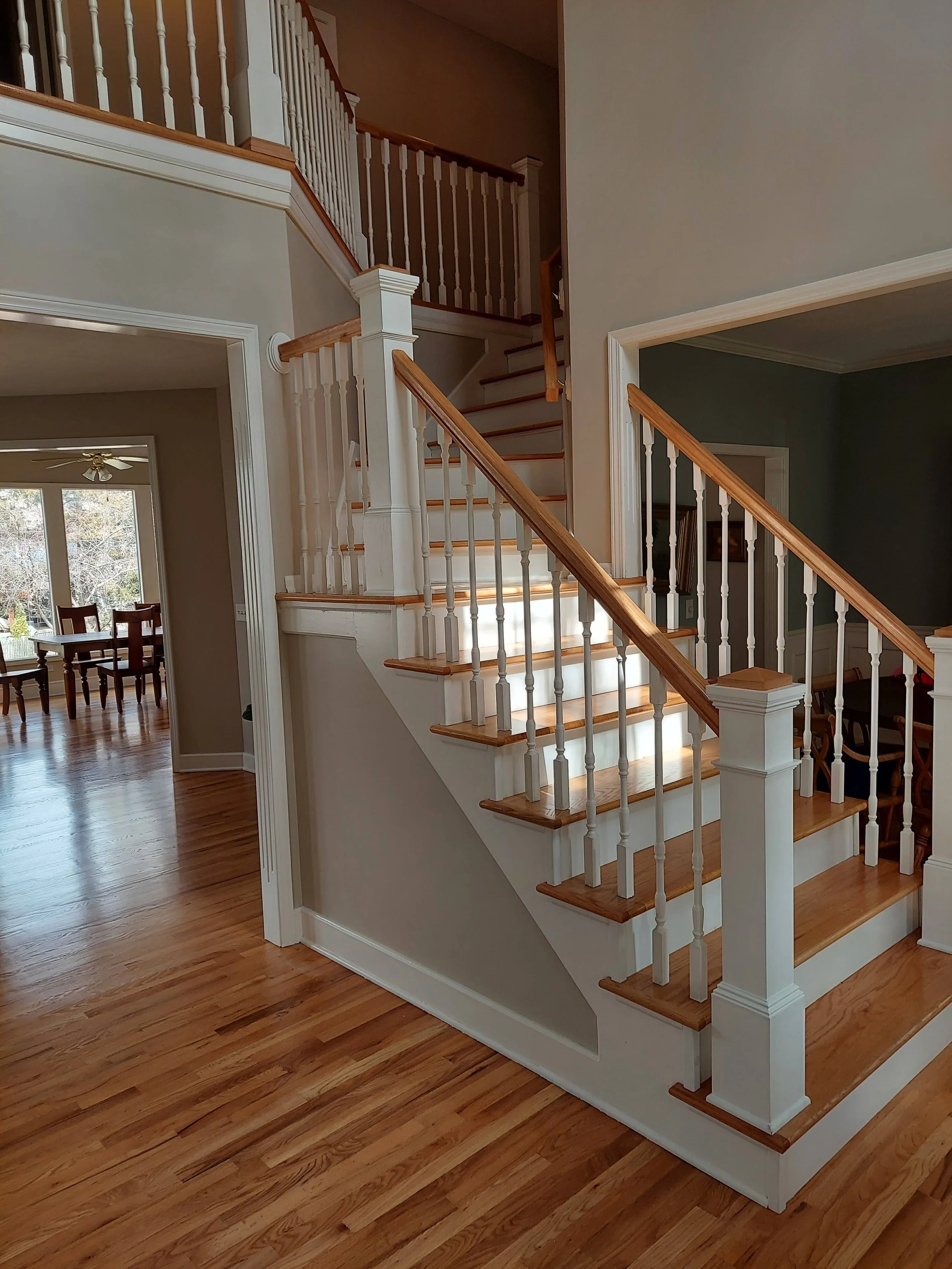 Finished hardwood staircase with custom handrail and balusters