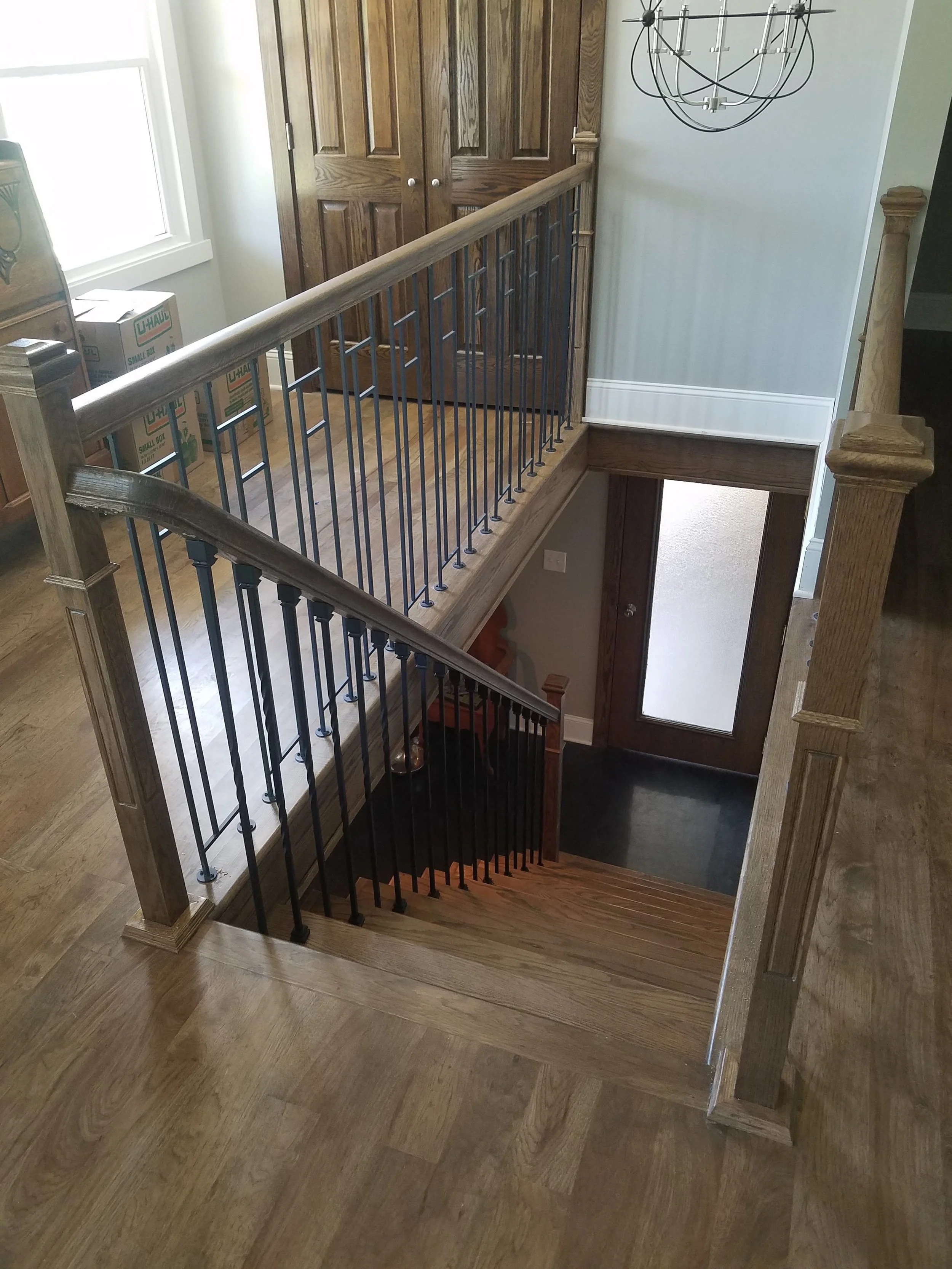 Custom wood handrail with black iron balusters