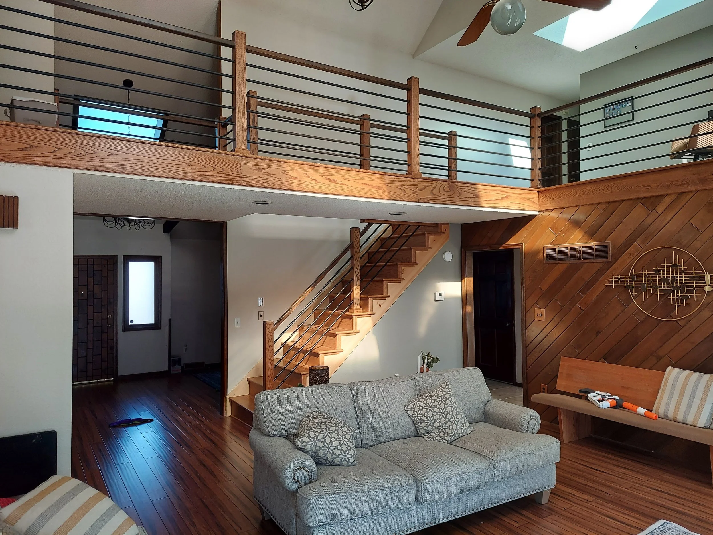 Custom horizontal railing overlooking living room