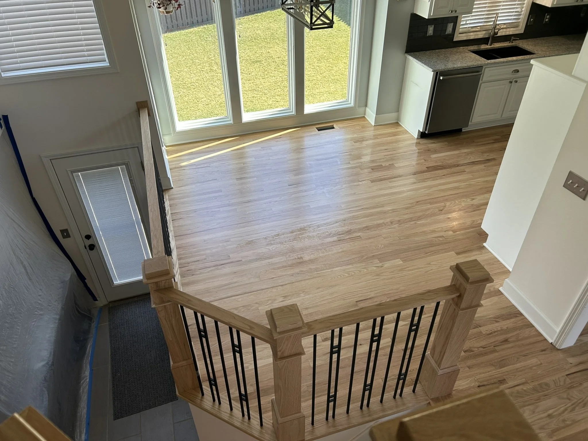 Hardwood breakfast room with custom wood and metal railing
