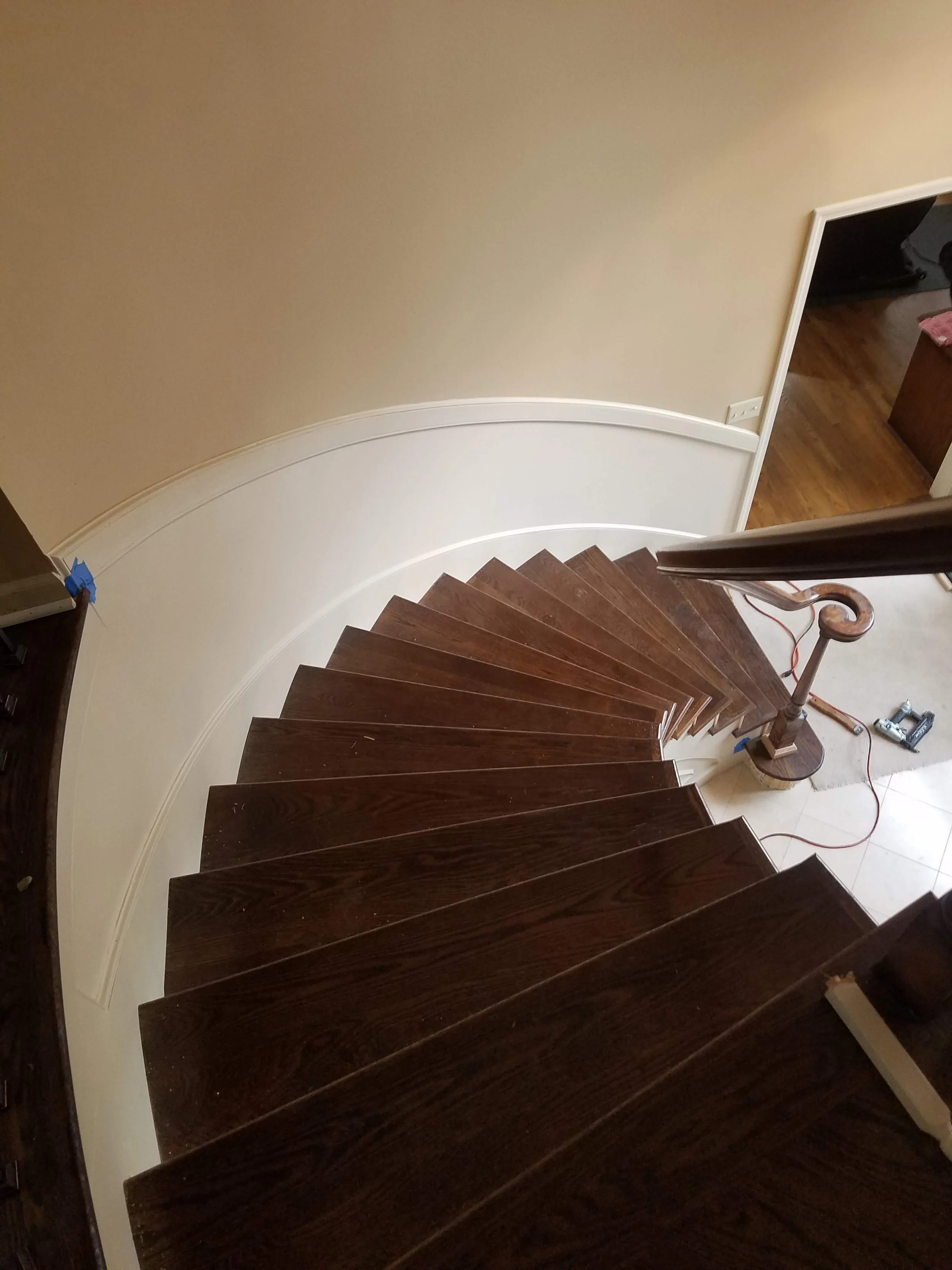 Curved hardwood staircase and custom handrail