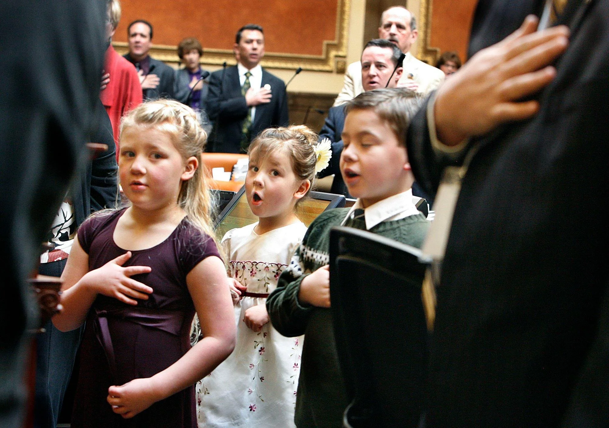 Photograph of the Wilcox kids, leading the Utah House in the Pledge of Allegiance. (Captured by his favorite photojournalist, Scott Sommerdorf)