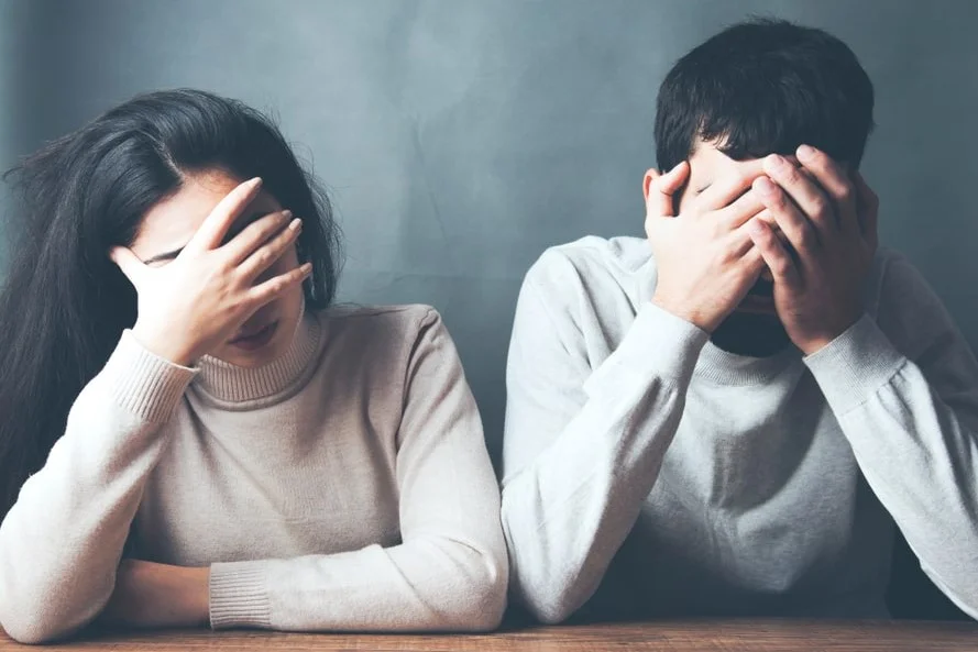 Nardella couple side by side hands over eyes-min.jpg