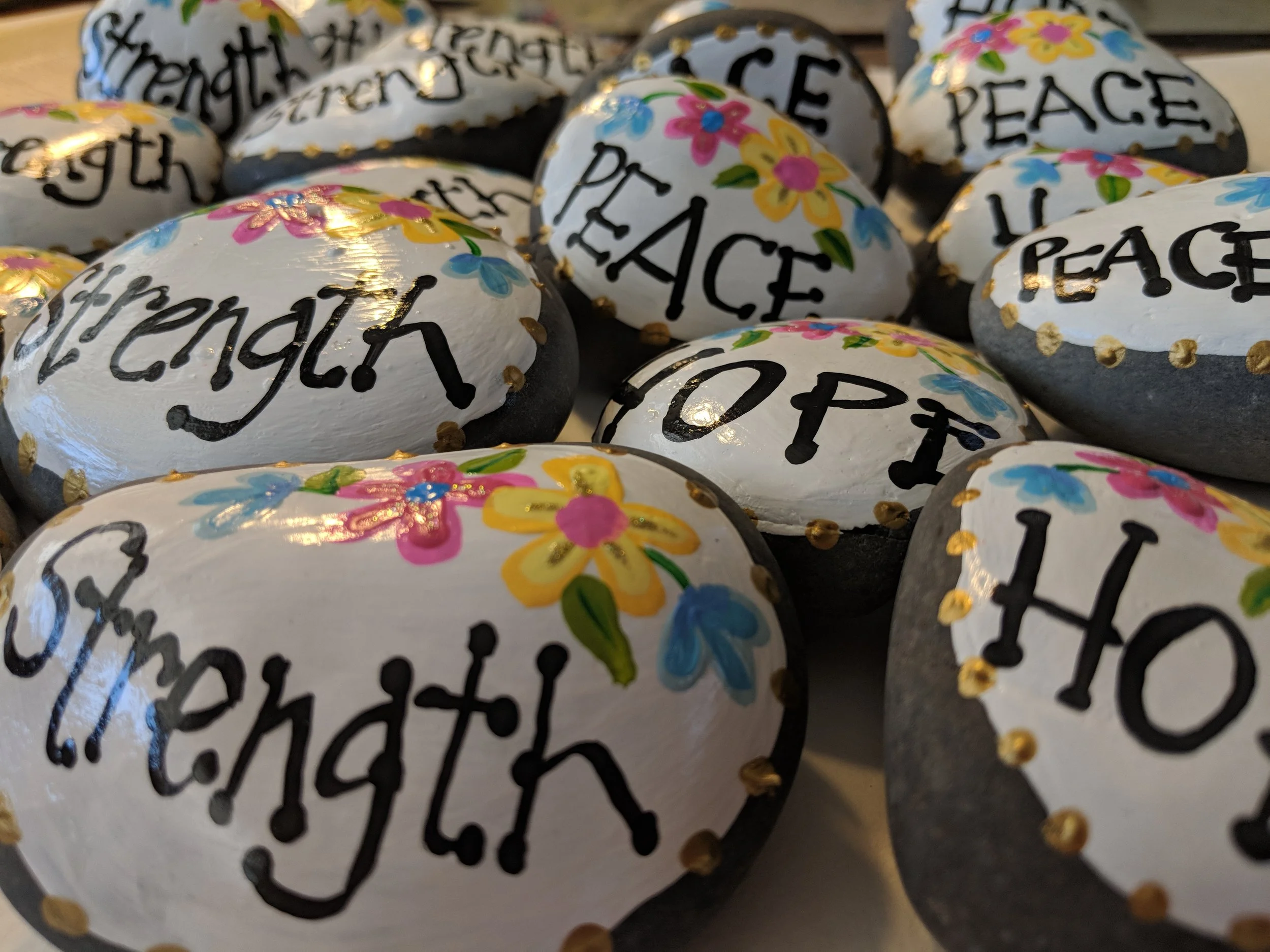 Hand painted rocks that I created and donated to an organization that hosted a retreat for women suffering child loss.