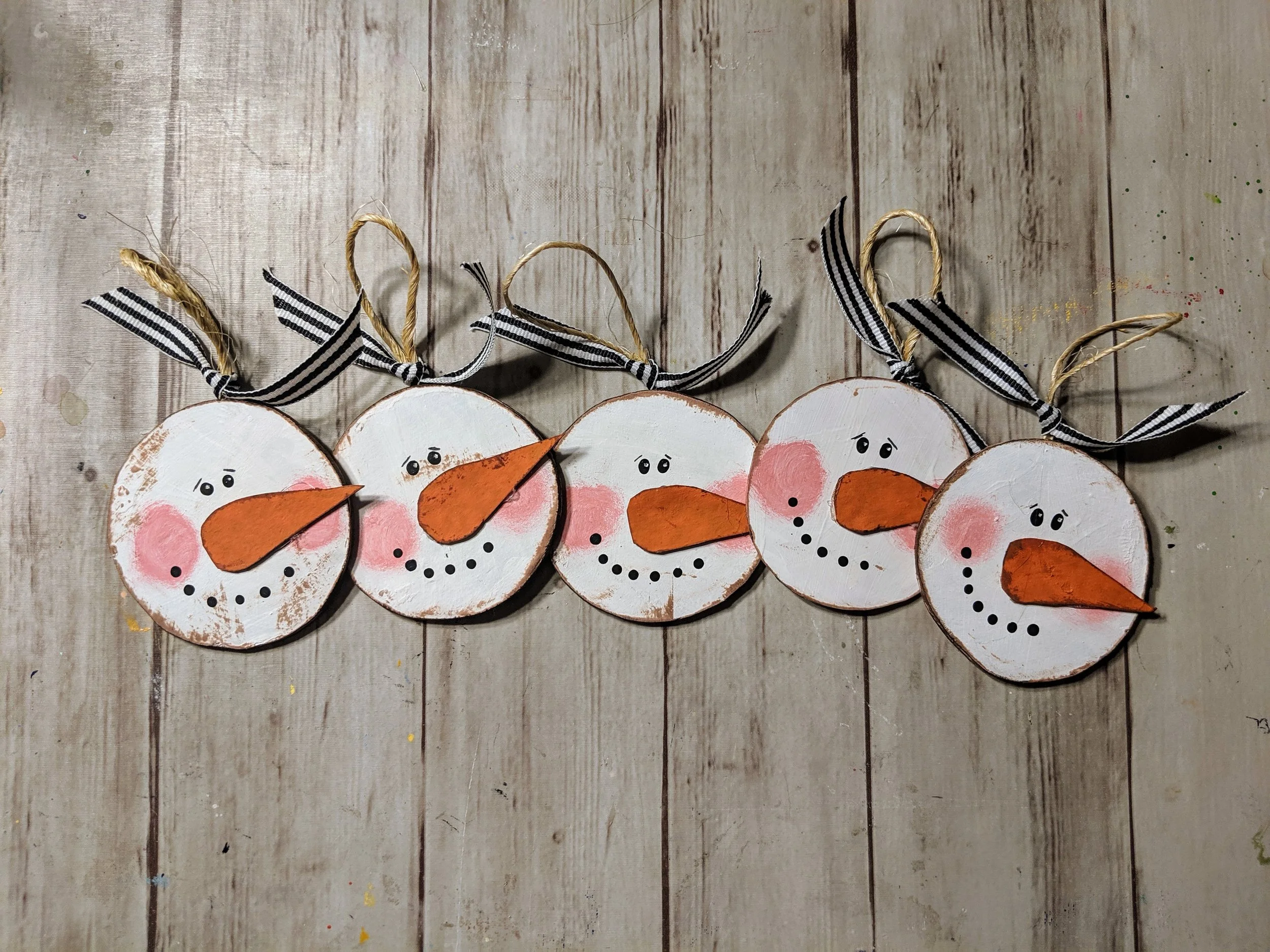 Adorable little snowman ornaments are all handmade from recycled paperboard and decorated with an eye catching black and white ribbon.