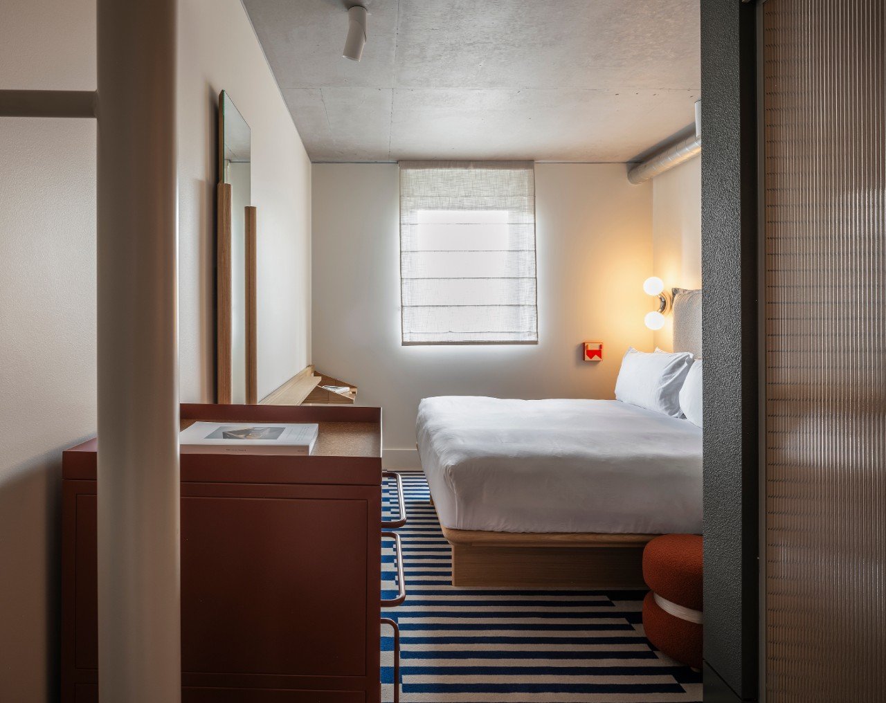 Hotel bedroom with cosy vies and curtain drawn at the back.