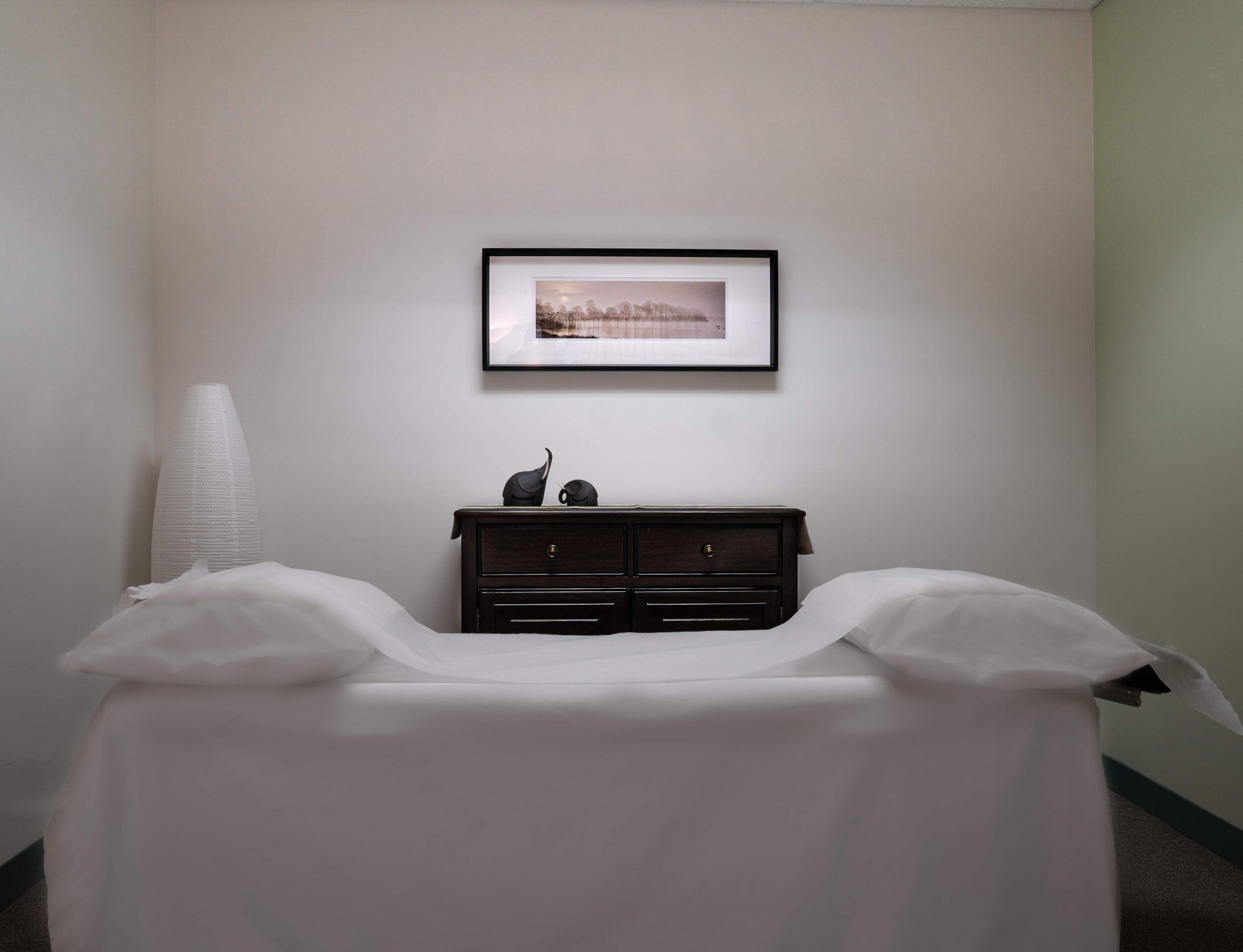 Acupuncture needles arranged on a smooth stone