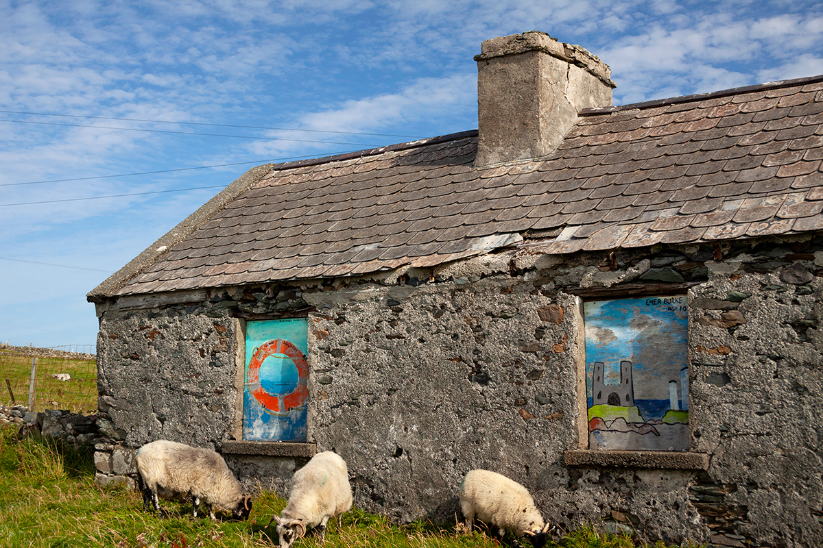 Empty cottage with childrens’ artwork in the windows, on Inishbofin island.