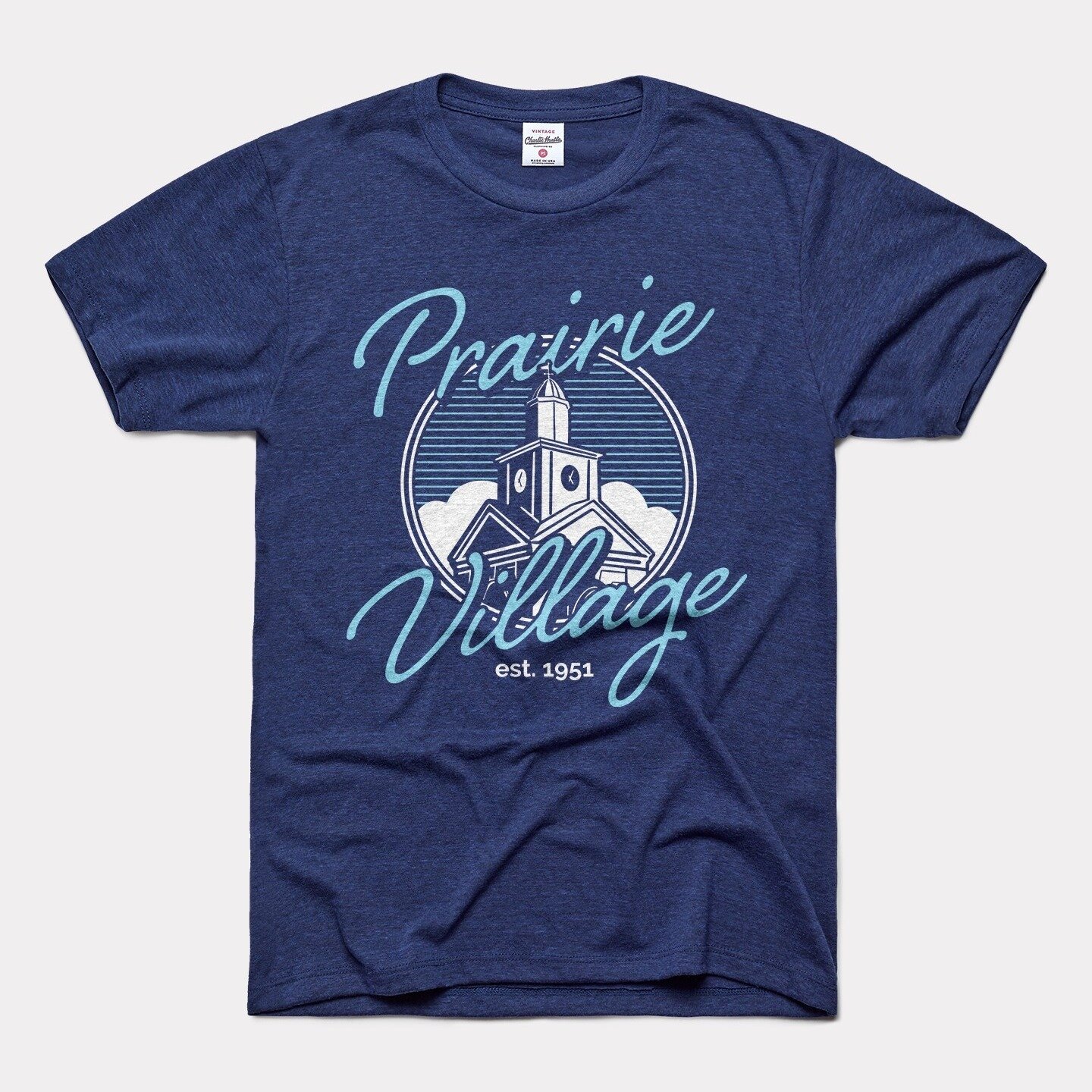 Be sure to purchase exclusive @prairievillageartshow merchandise! 

Exclusive @charliehustleco X Prairie Village shirts in vintage white or heather navy will be on sale for $30 at the Information Booth near the clock tower. 

The following items will