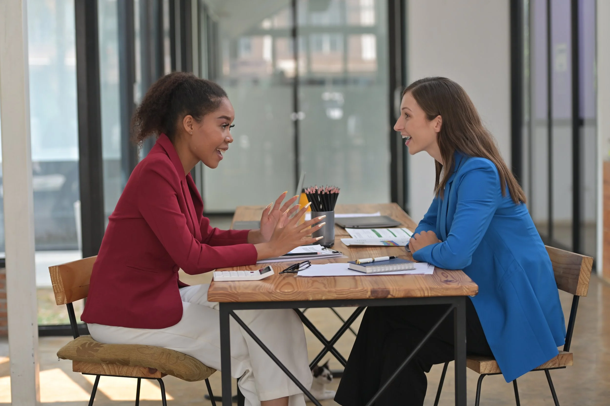 two-women-are-sitting-at-a-table-talking-to-each-2025-01-10-13-32-11-utc.JPG