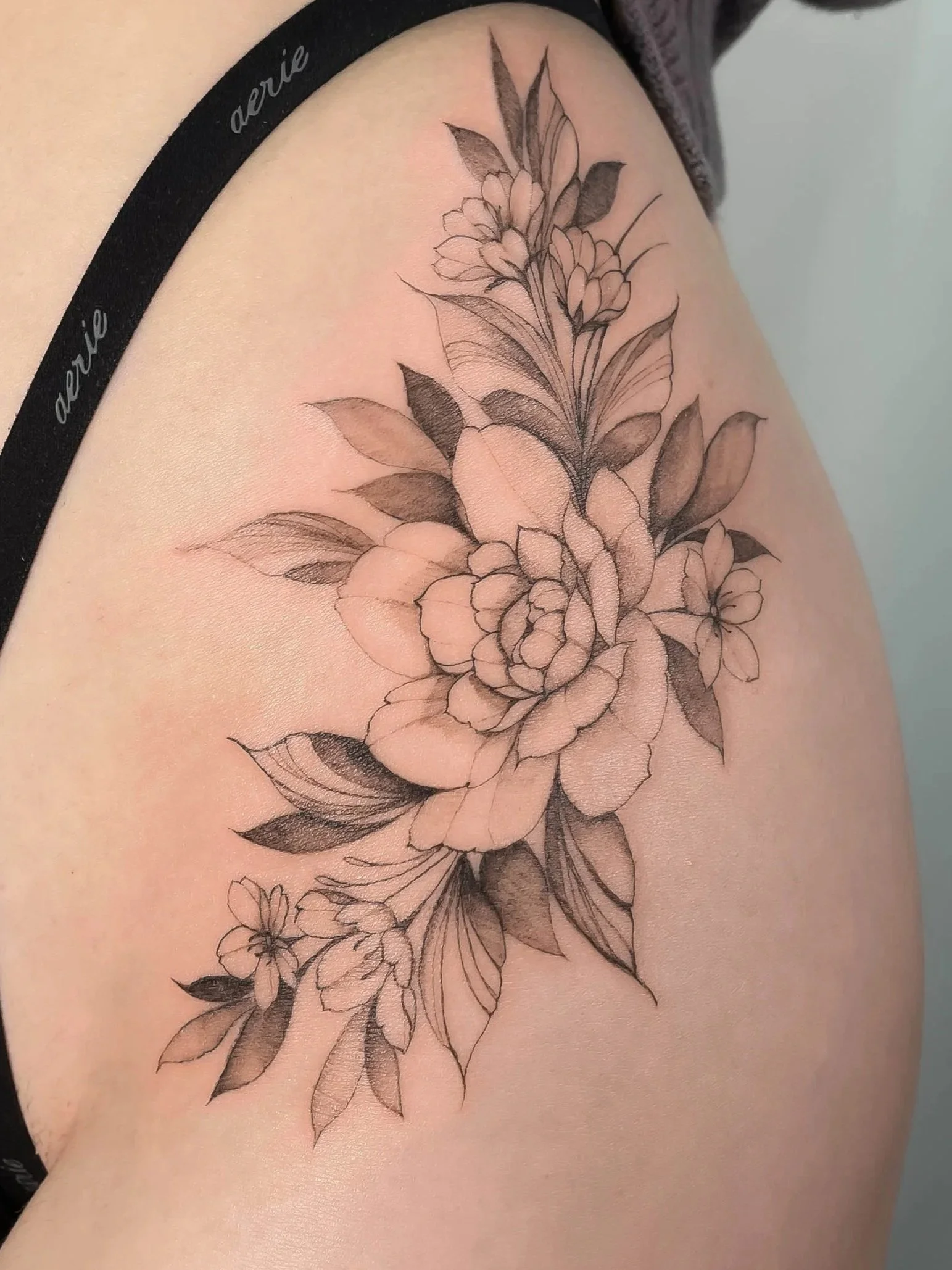 Delicate floral fine line tattoo by Calgary artist Connie Taing at 9 Element Tattoos.