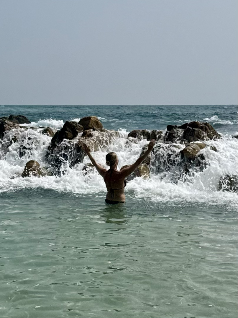 A retreat guest enjoying a quiet moment in the Indian Ocean during the Sri Lanka retreat.