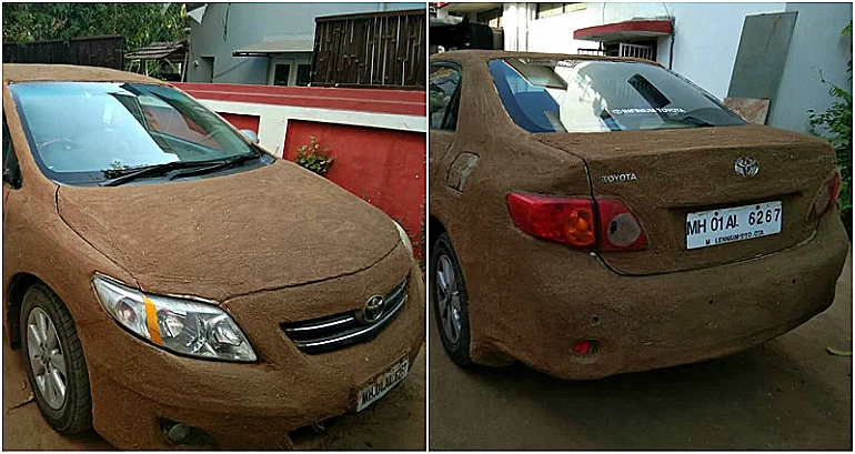 Car in India covered in dung to protect from rising temperatures.