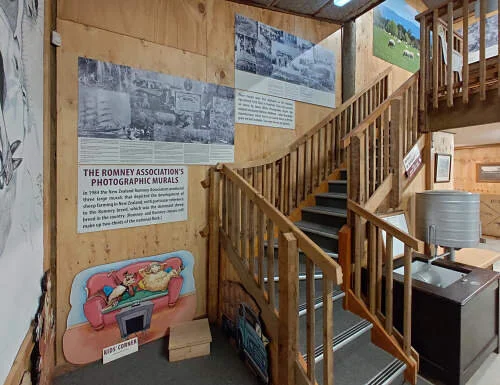 Stairs to the mezzanine gallery, showing some of the vintage photographic sheep industry murals produced by the Romney Association in 1984. More of these murals are on the mezzanine floor.