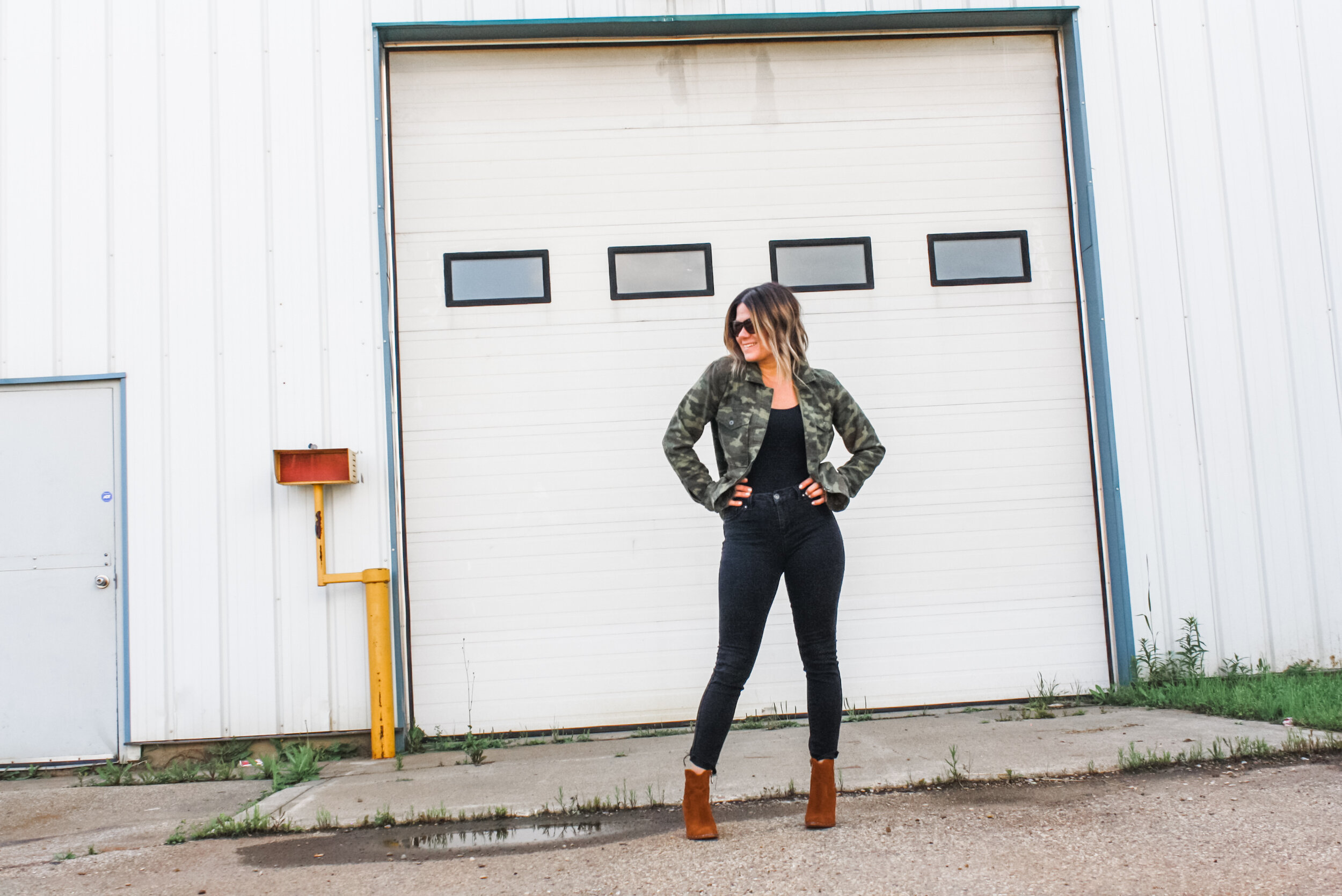  This outfit makes a statement. Who doesn't love all black and then add cognac boots and camo to switch things up a bit. This says just grab a glass of wine, gather the girls and have a great time! 