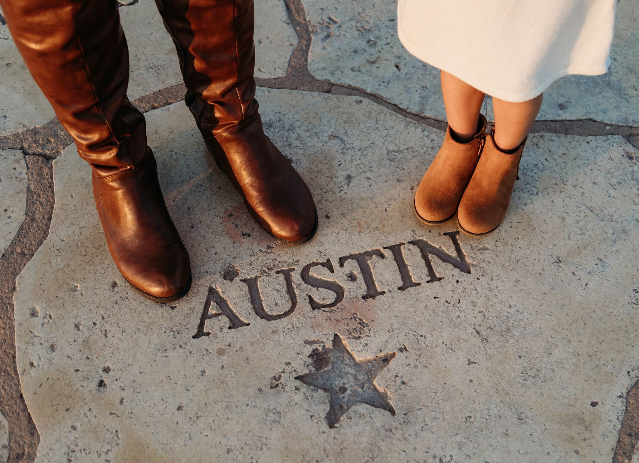 Raechal Martin and her daughter's feet standing in Austin, TX