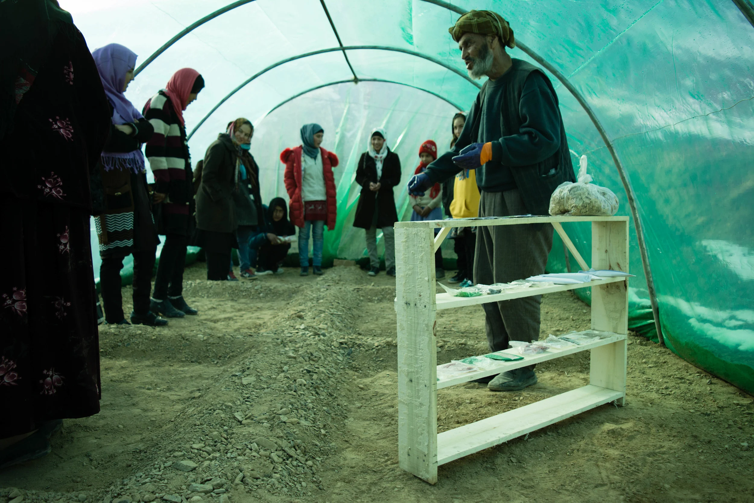 NGO partner COAM, delivers environmental lessons to students in a local greenhouse