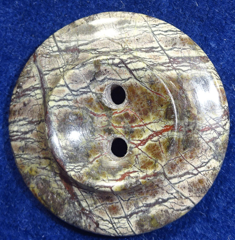 Polished serpentine rock button