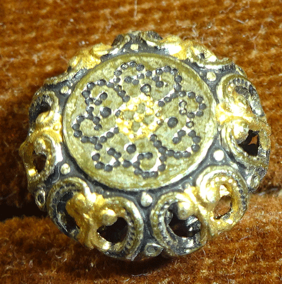 Small pressed and pierced metal buttons