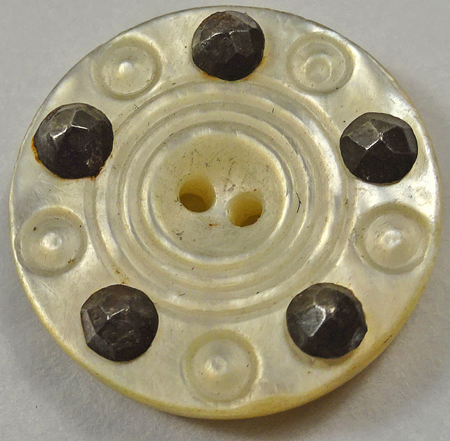 Pearl button studded with facetted steels