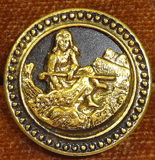 Gilt metal Heidi sitting among rocks