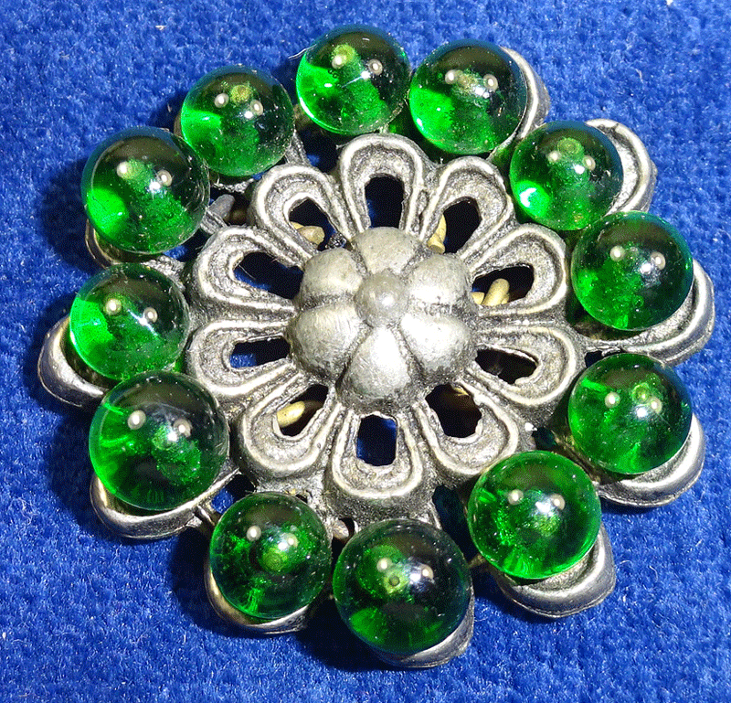 Green glass on grey metal, embellishment
