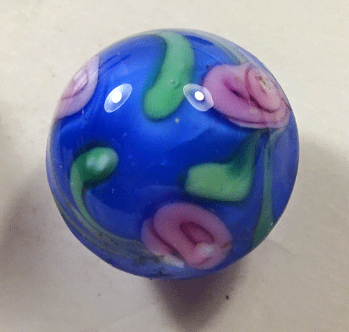 Small blue glass ball with pink roses
