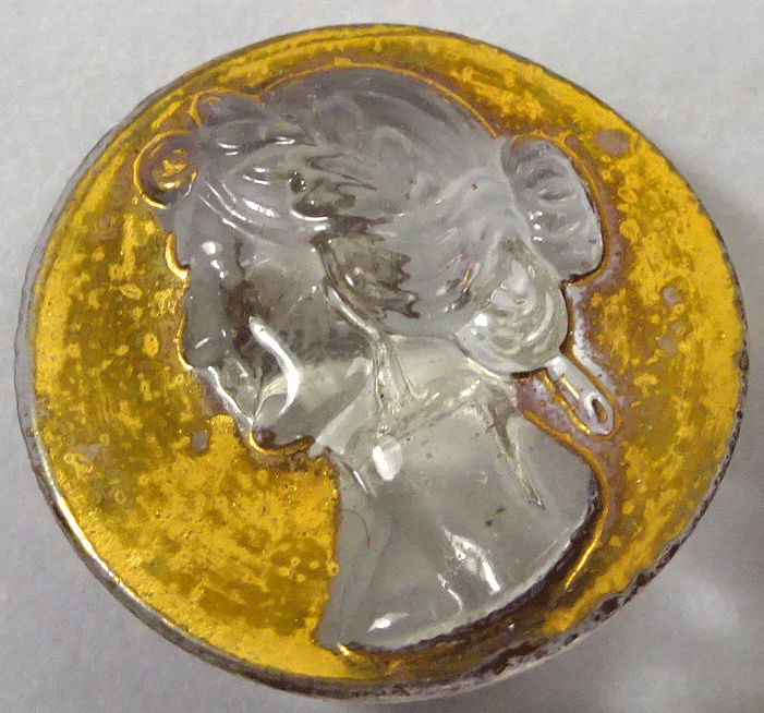 Clear glass female head on gold
