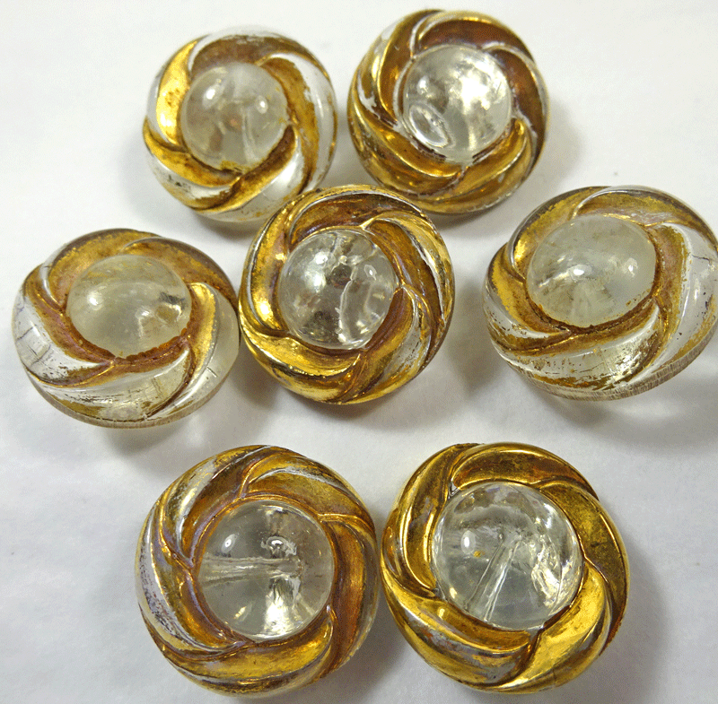 Set of 7 clear glass buttons with gold rims