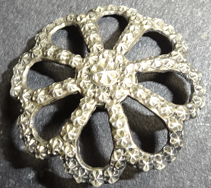 Pressed and pierced white metal flower