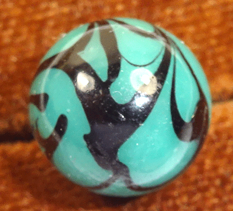 Green glass ball, with splashes of black