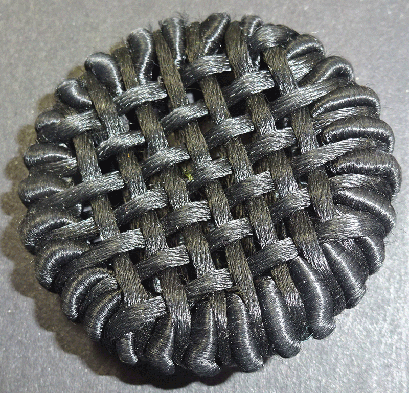 Large, black woven cord button