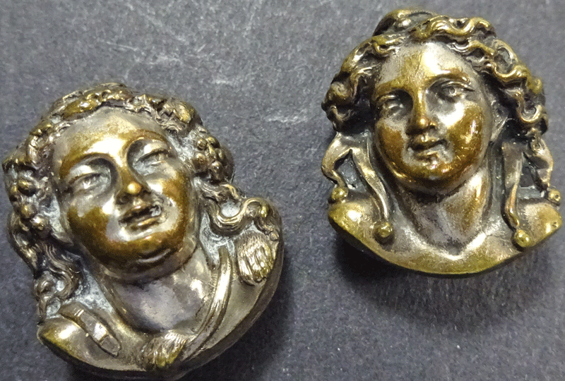 Pair of antique stud buttons, child's face