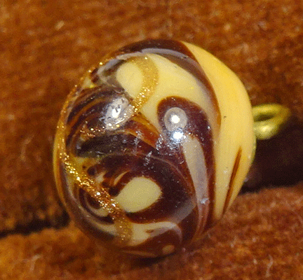 Small caramel glass ball with brown swirls