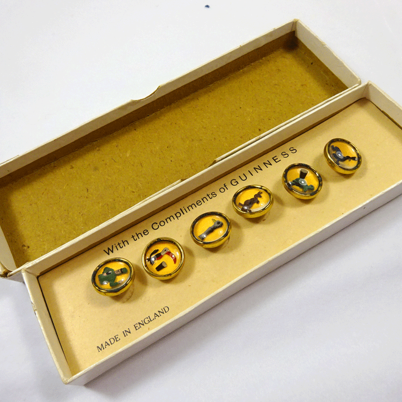Boxed set of Guinness advertising waistcoat buttons