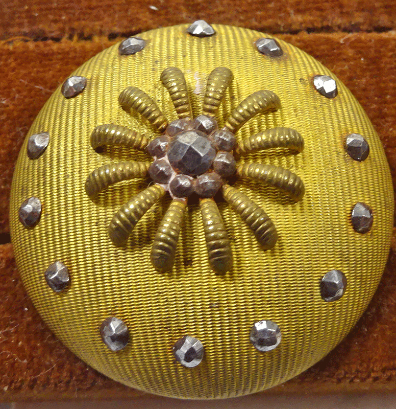 Domed textured gilt metal with cut steels