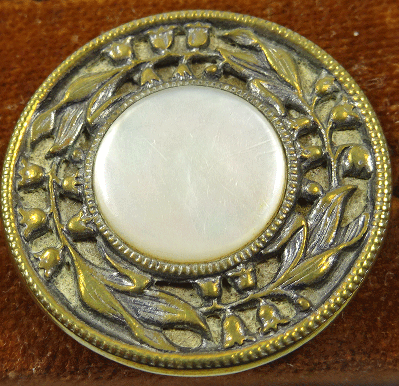 Vintage mother of pearl button with floral rim