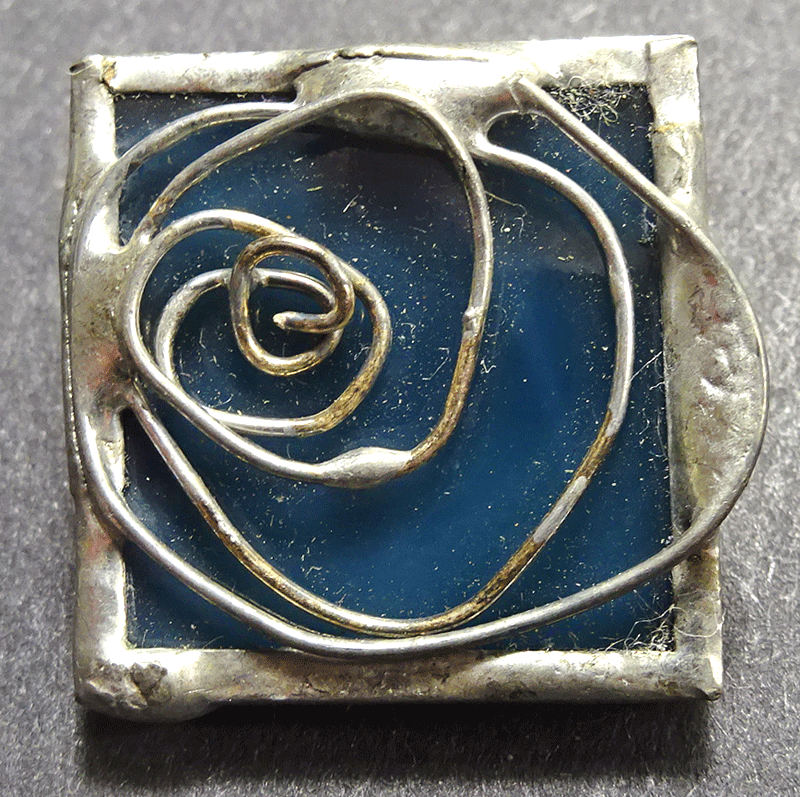 Blue square with stylised metal rose