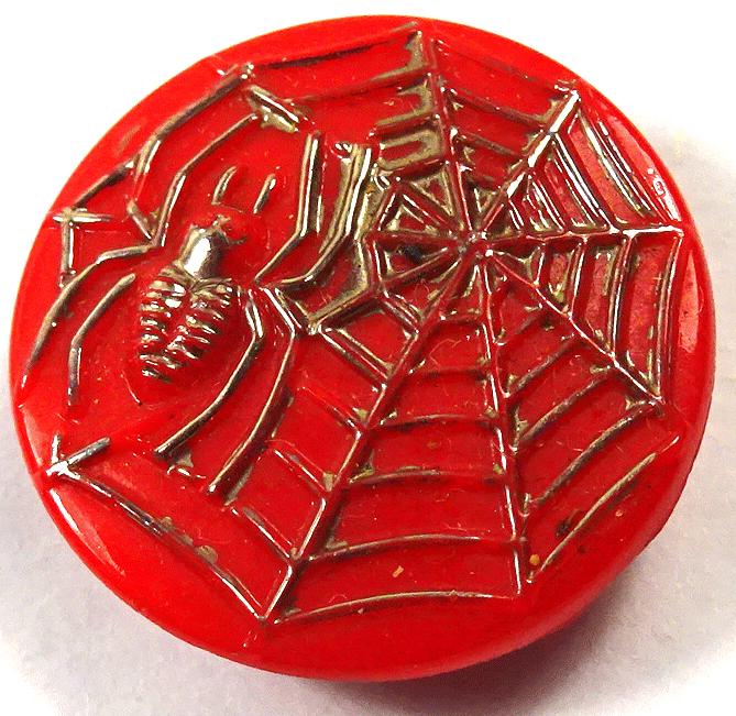 Silver spider on red glass