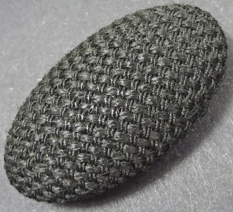 Large oval buttons, black woven fabric