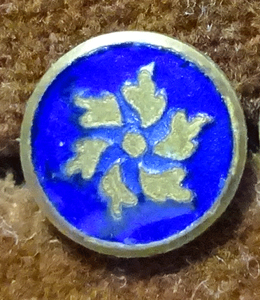 Small metal flower, blue enamel background