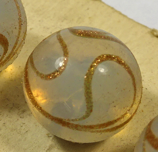 White glass waistcoat ball with gold swirls