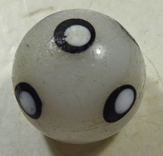 White glass waistcoat ball with black and white spots