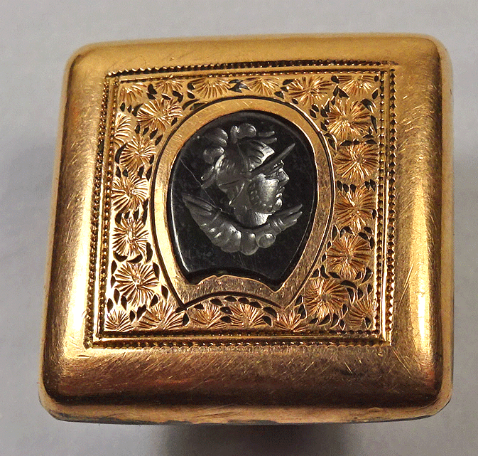 Black glass head in gilt metal square, stud shank