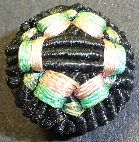 Small corded button, with interwoven ribbon