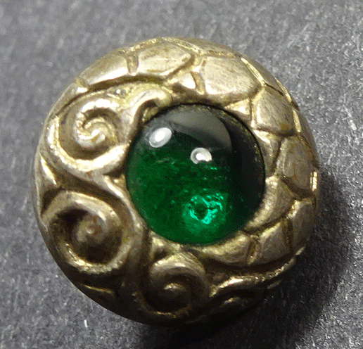 Small pressed white metal with green paste